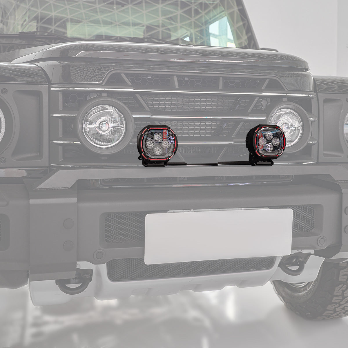 PLOMOR aluminium and steel front bumper light mount bracket for Ineos Grenadier. Gloss black finish, custom-fit for two spotlights or one light bar.