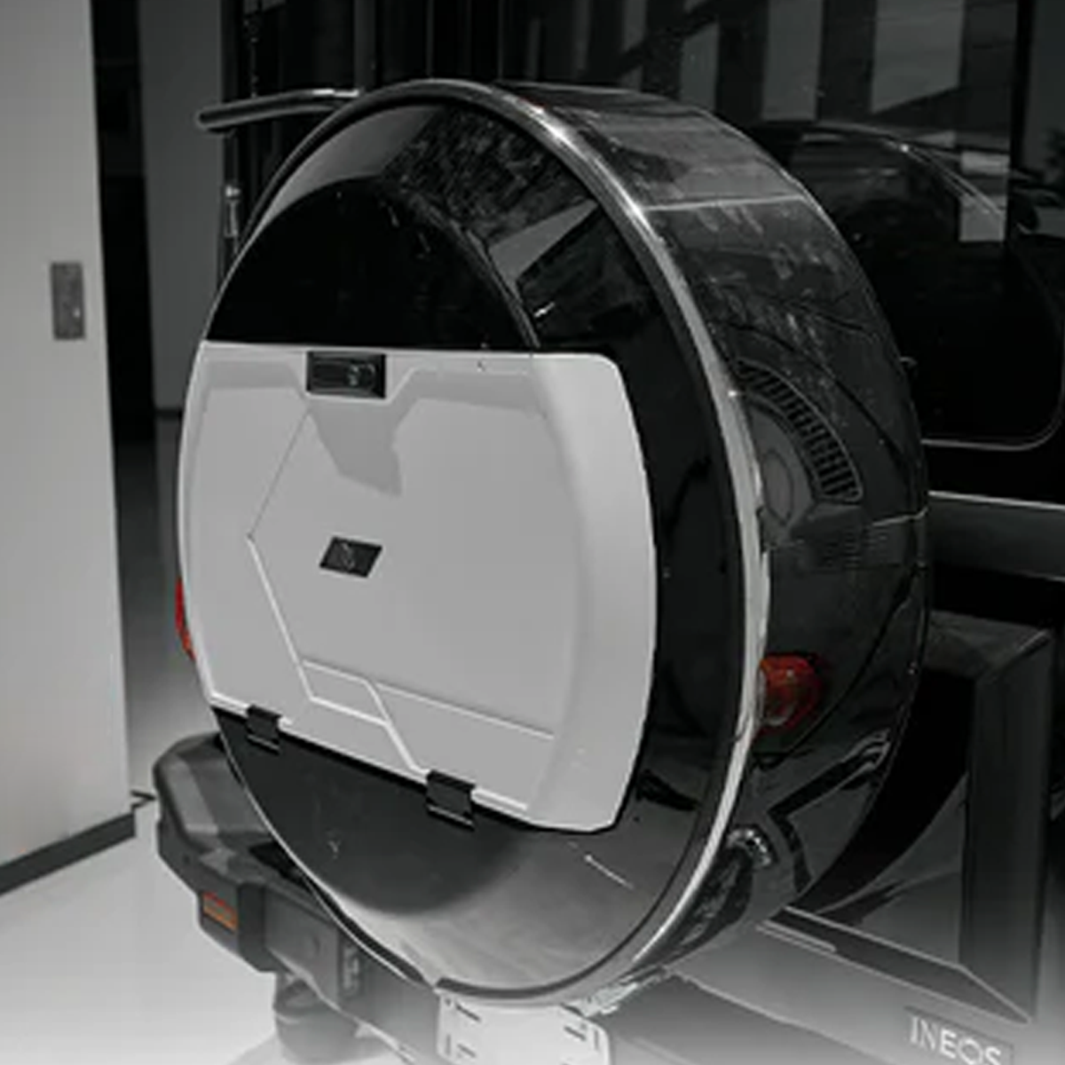 “Black and white spare wheel cover for INEOS Grenadier, weather-resistant design offering durable protection and modern styling.”