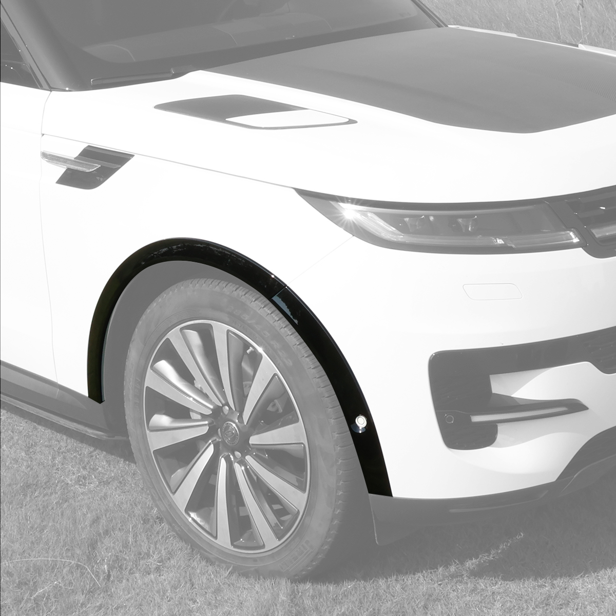 Close-up of PLOMOR gloss-black front fender flare installed on Range Rover Sport L461 (2023+), left side, showing OE-style fitment.