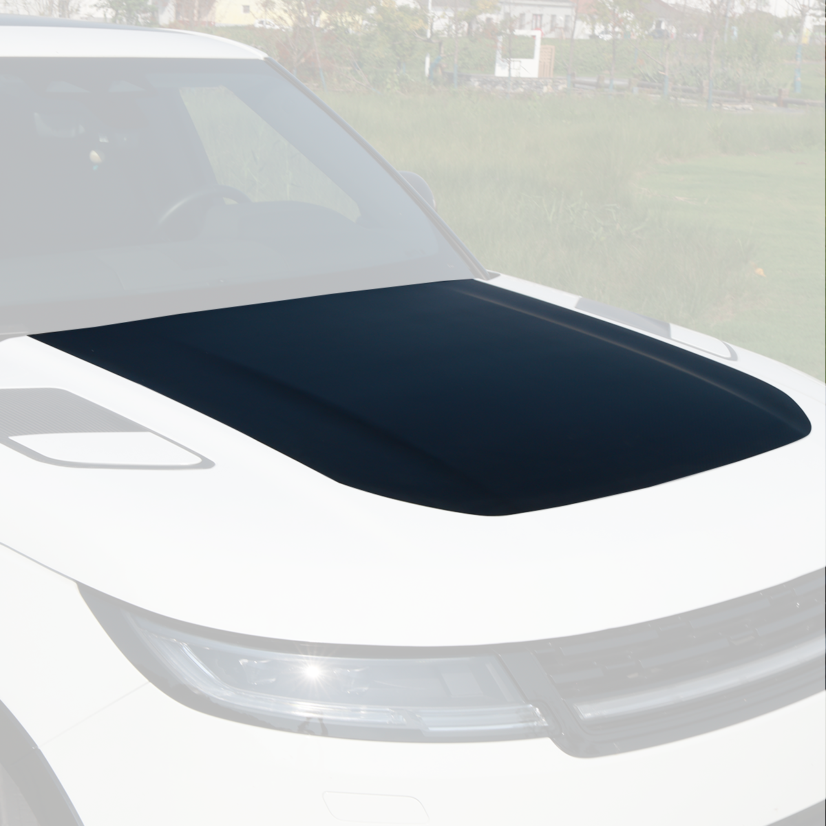 Installed view of PLOMOR hood/bonnet panel on Range Rover Sport L461 (2023+), black paint-ready finish, driver-side front three-quarter.