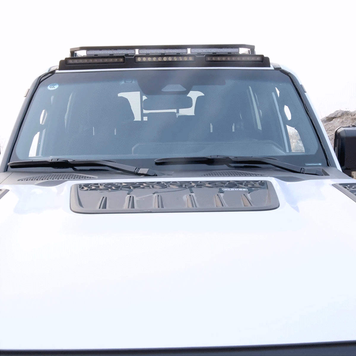 Glossy black ABS triple roof lighting cover for Toyota Land Cruiser 250, mounted on roof rack with LED lights.
