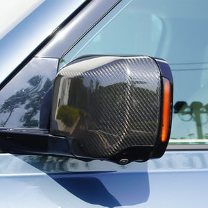 Urban driving view of Land Rover Defender with PLOMOR Carbon Fiber Mirror Covers