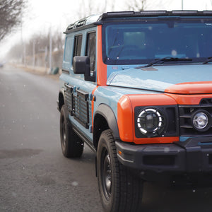 PLOMOR heavy-duty steel body side utility panel for Ineos Grenadier. Features a MOLLE grid system for mounting exterior overlanding and recovery gear.
