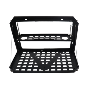 PLOMOR Tailgate Folding Table securely mounted to the INEOS Grenadier inner tailgate, folded down to provide a stable camp kitchen surface or tool shelf with tension support cables visible.