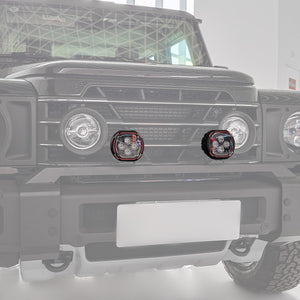 PLOMOR dual-function round LED spotlights for Ineos Grenadier. Features a bright white beam and an amber halo ring for use as DRL or turn signal.