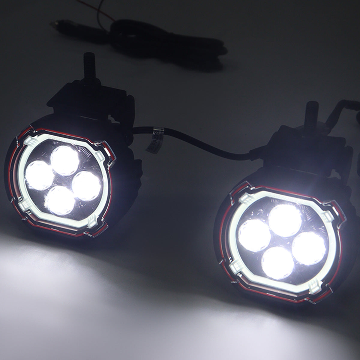 PLOMOR dual-function round LED spotlights for Ineos Grenadier. Features a powerful white beam and an amber halo DRL/turn signal in a custom, plug-and-play design.