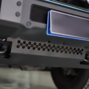 PLOMOR heavy-duty steel front skid plate for INEOS Grenadier. Designed to shield the engine, differential, and steering components during rugged off-road driving.