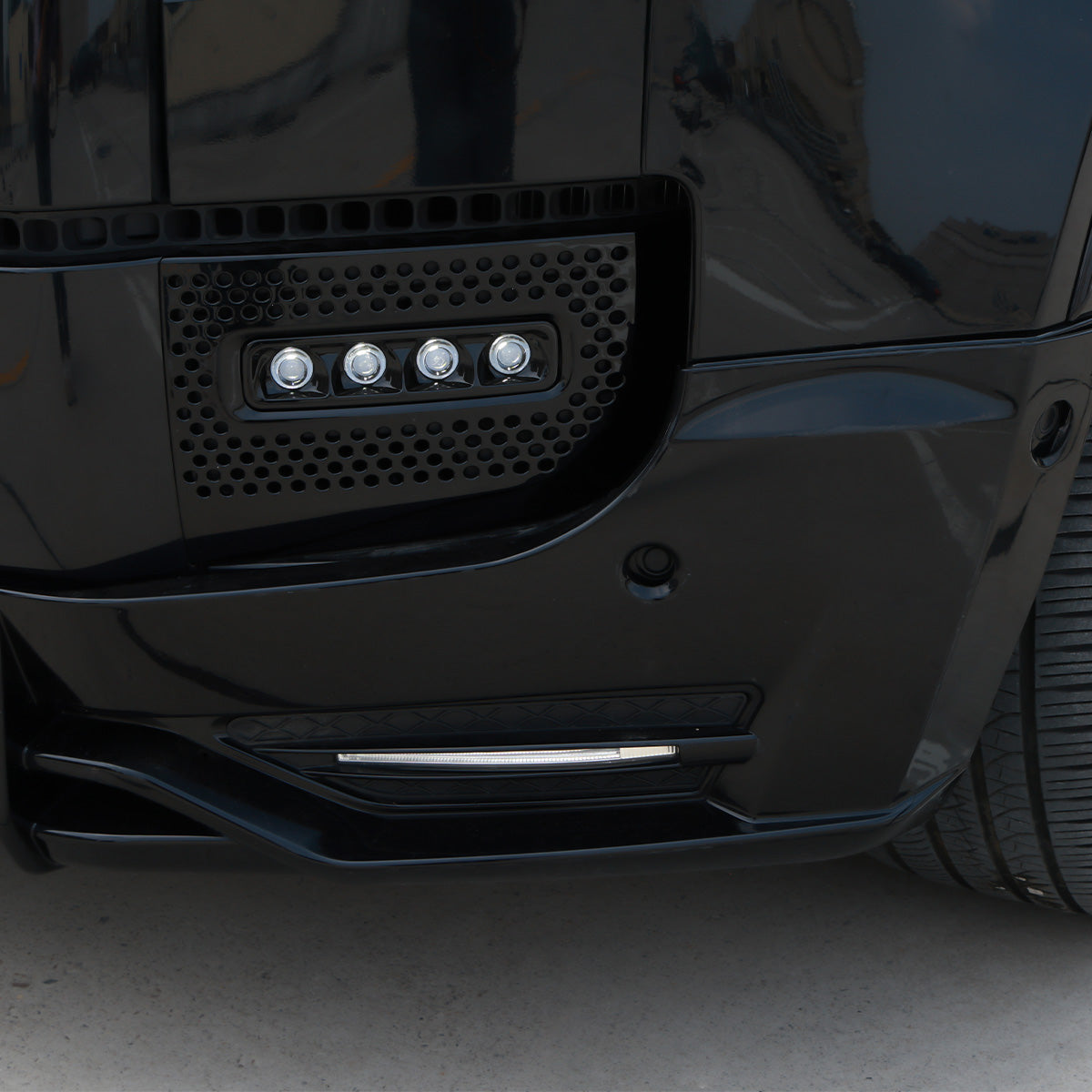 LED front lip splitter installed night view on Defender
