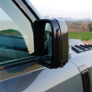 Close-up of installed PLOMOR Dynamic Amber LED Side Mirror Indicator on Defender L663