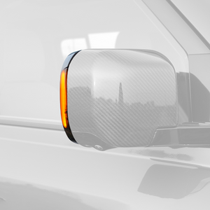 Land Rover Defender 90/110/130 with PLOMOR Amber LED Side Mirror Indicator illuminated at night