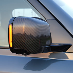 Side view of Defender 110 with PLOMOR Dynamic Amber LED Side Mirror Indicator installed