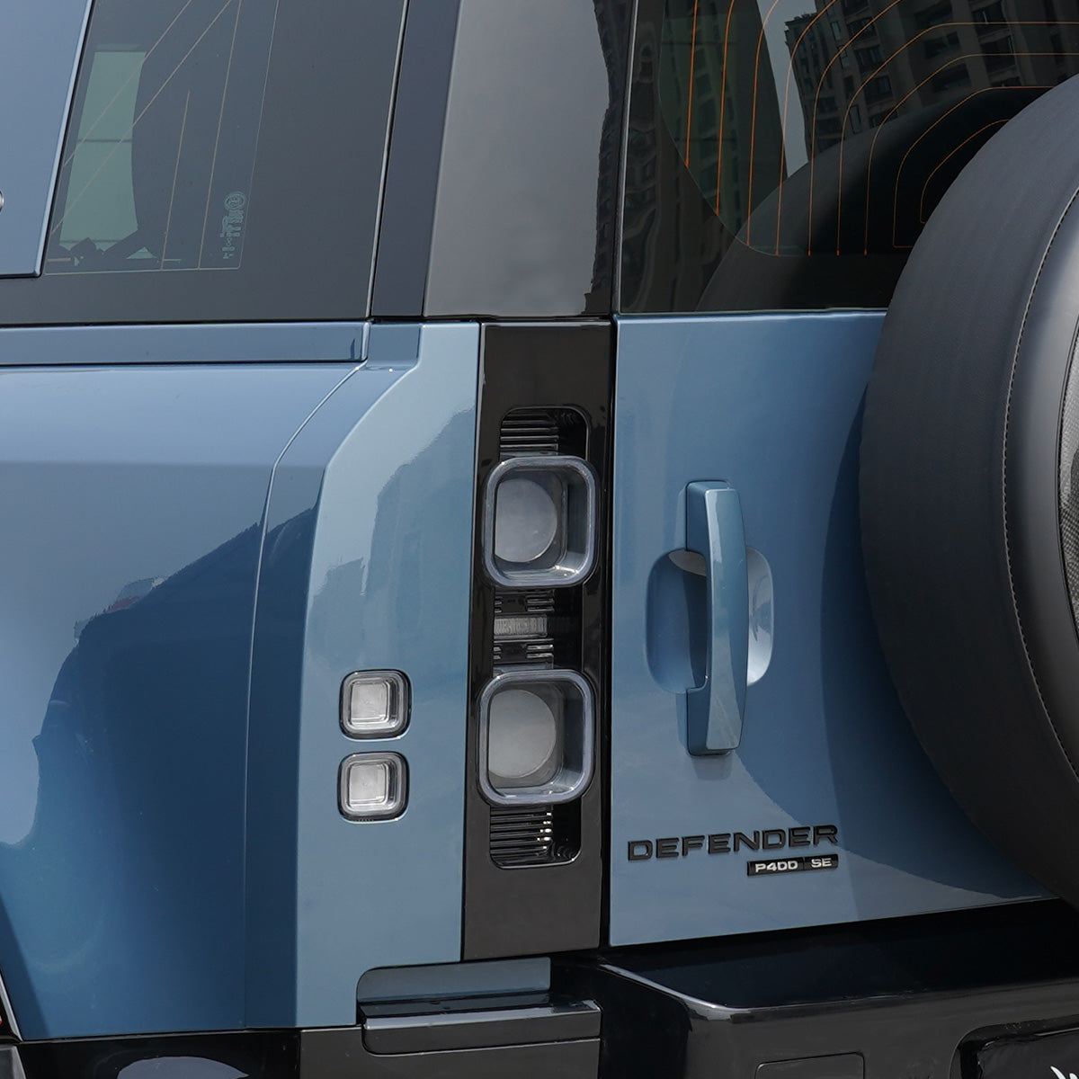 Step showing easy plug & play installation of PLOMOR LED tail lights on Defender