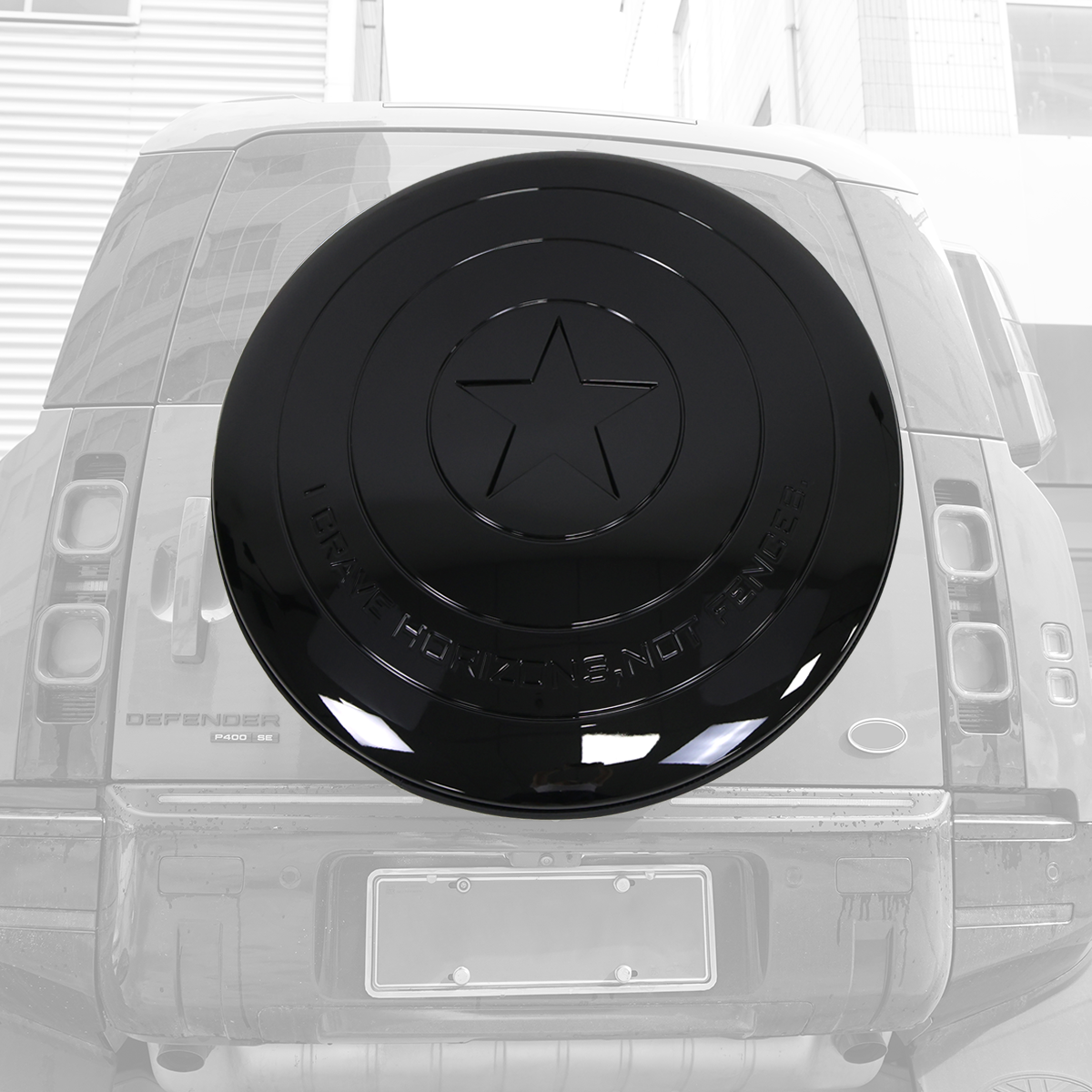 Defender driving city road with star spare wheel cover installed black ABS cover