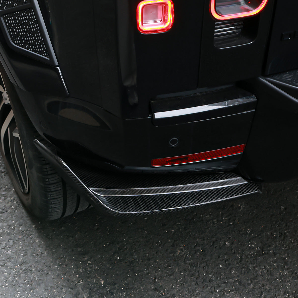 Side view gloss black rear corner guards installed on Defender