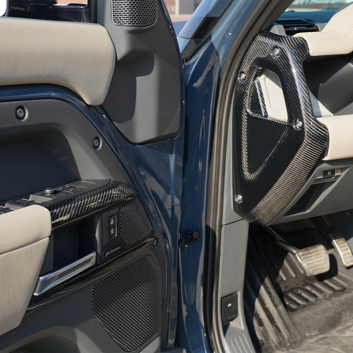 Land Rover Defender steering wheel carbon fiber trim installed close up detail