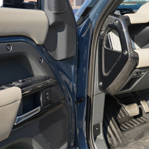 Land Rover Defender steering wheel carbon fiber trim installed close up detail
