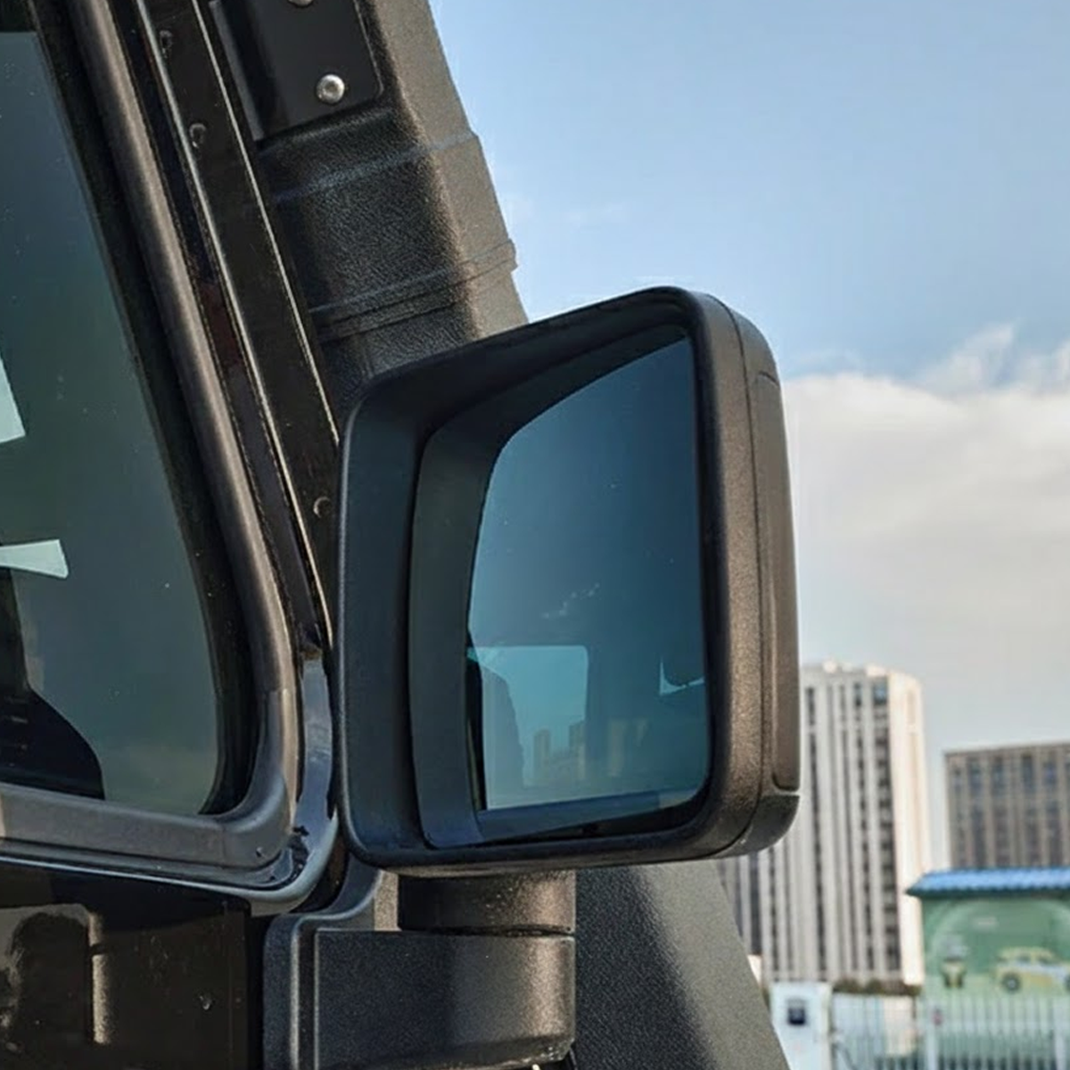 Blue-tinted wide-angle mirror glass installed on INEOS Grenadier, reducing glare and improving visibility during night-time driving