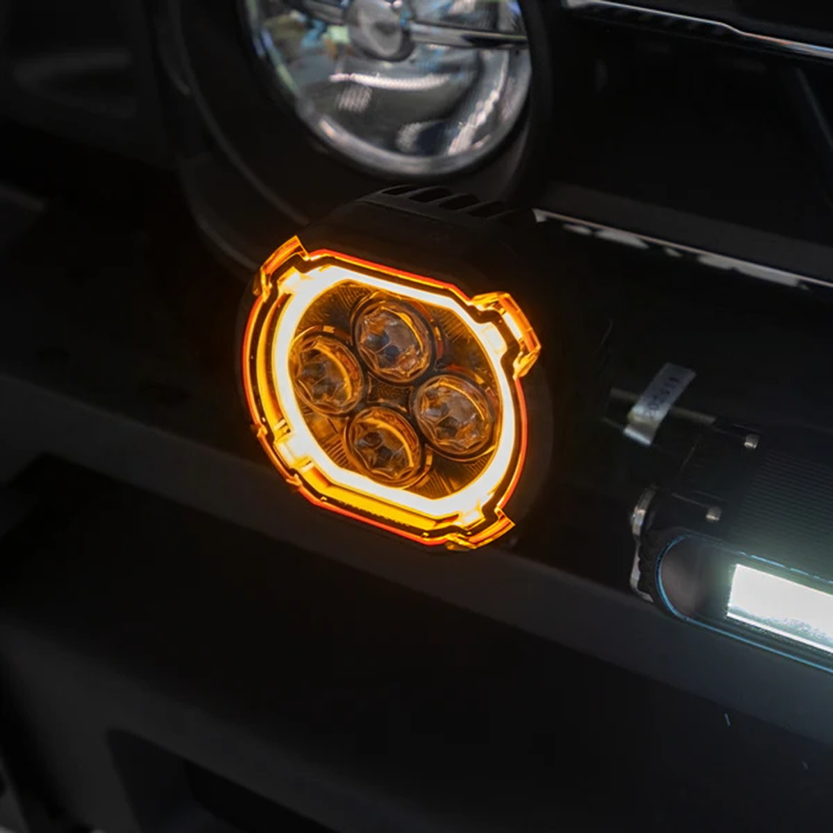 Dual-function LED spotlights installed on INEOS Grenadier featuring white beam and amber halo ring