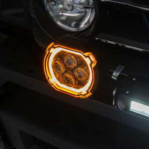 Dual-function LED spotlights installed on INEOS Grenadier featuring white beam and amber halo ring