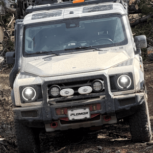 INEOS Grenadier with PLOMOR heavy-duty front bumper during off-road driving