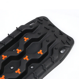 "Ineos Grenadier off-road black aluminium headlight guards in use on rough terrain"