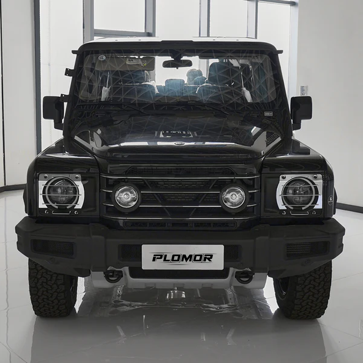 Black aluminium front headlight guards installed on INEOS Grenadier 2020–2024, providing rugged OEM-style protection.