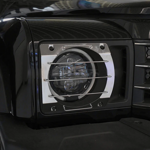 Close-up of black aluminium alloy headlight guard installed on INEOS Grenadier, corrosion-resistant and precision fitted.