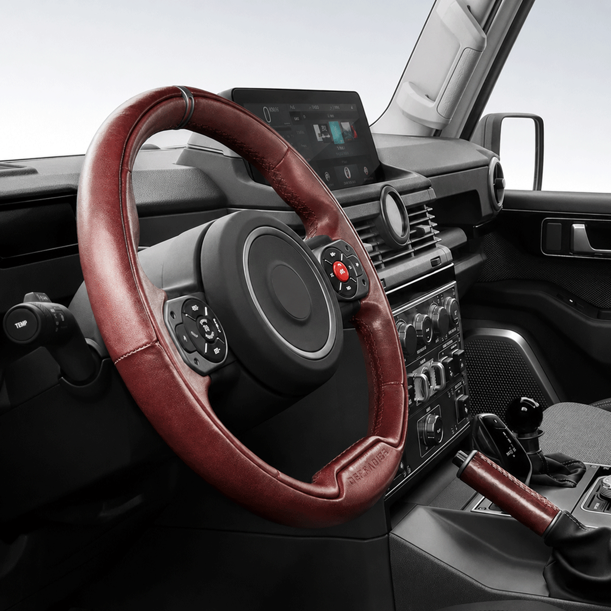 Close-up of driving hands holding PLOMOR leather steering wheel cover installed on INEOS Grenadier