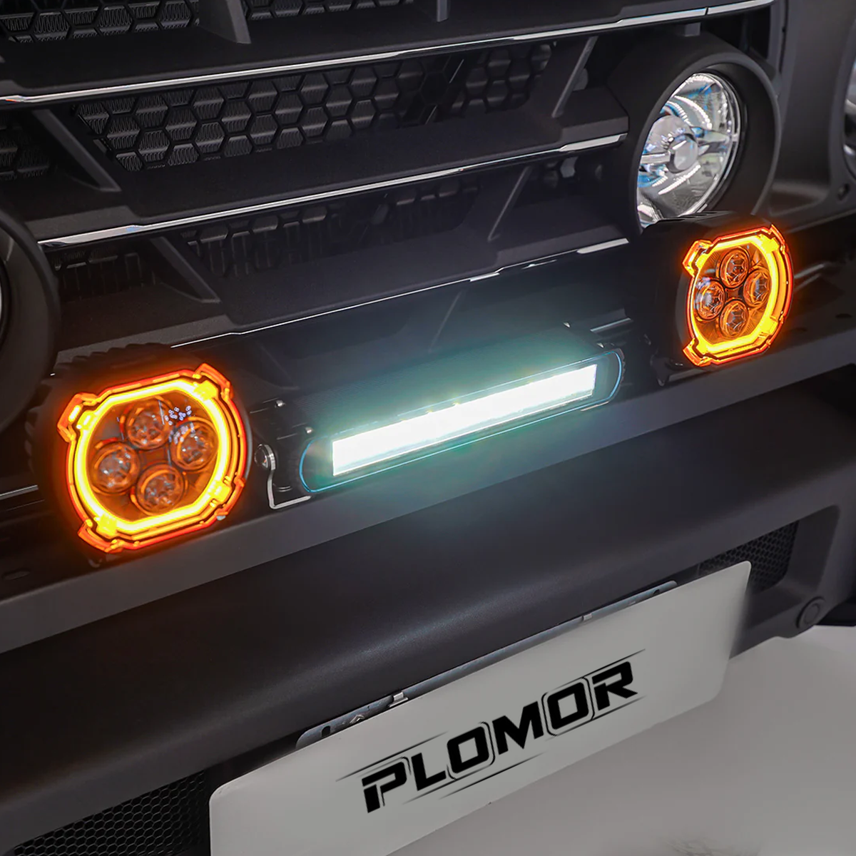 Off-road INEOS Grenadier equipped with rugged dual-function LED spotlights with amber halo DRL