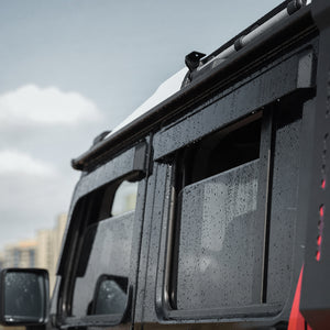 Matte black PLOMOR window visors on Ineos Grenadier off-road driving