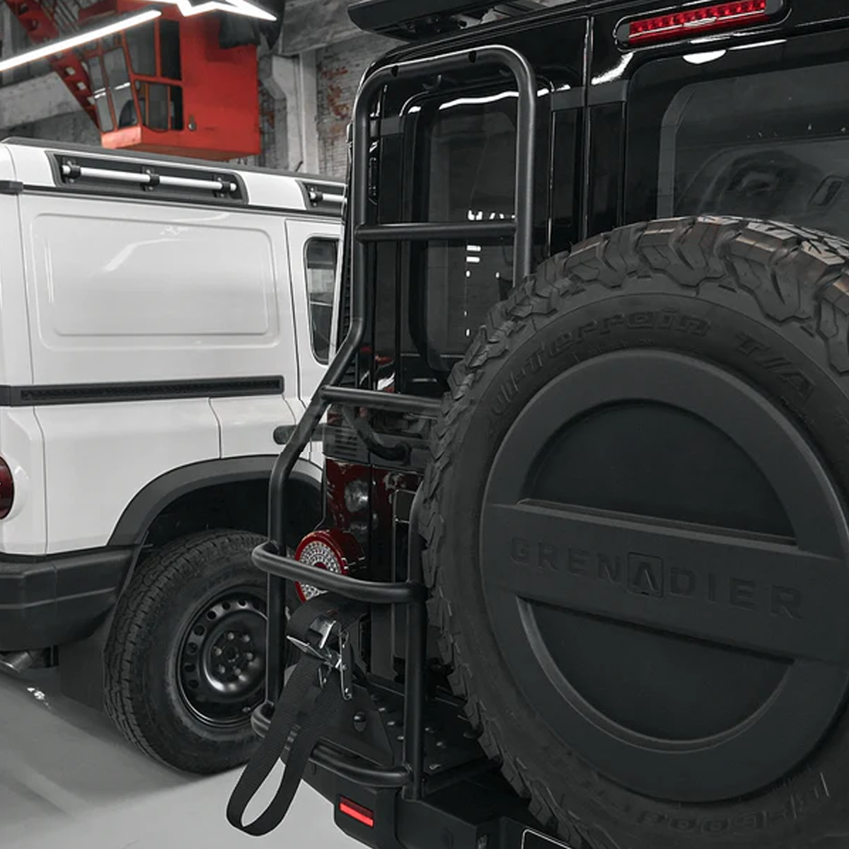 Heavy-duty rear ladder rack fitted on INEOS Grenadier tailgate, designed for secure access and off-road functionality.