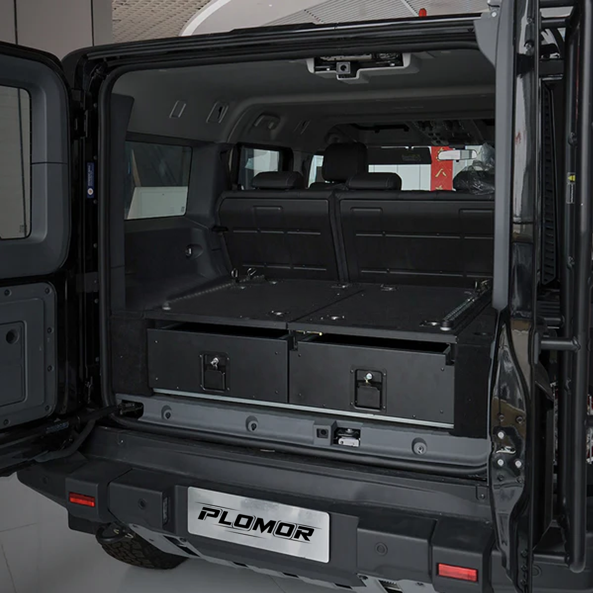 PLOMOR rear trunk drawer system installed in the INEOS Grenadier 2023+, creating an organised and secure cargo area