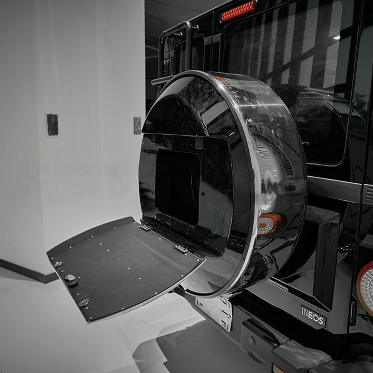 “INEOS Grenadier spare wheel cover installed on rear, weather-resistant protection with modern styling.”
