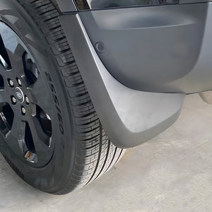 Land Rover Defender 90 matte black mud flap on off-road terrain