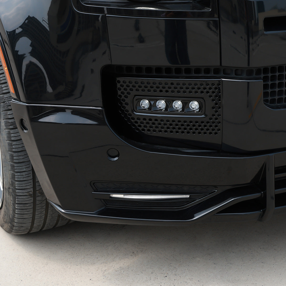 Close-up installed front lip splitter on Defender