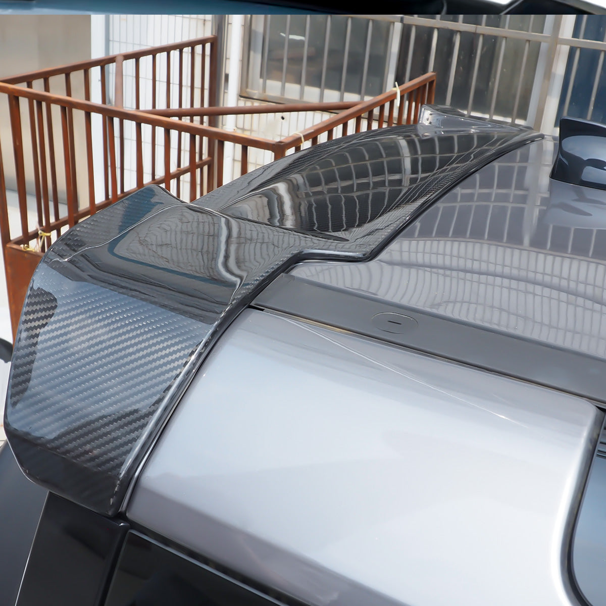 Side view of carbon fibre rear roof spoiler installed on Defender L663 90/110