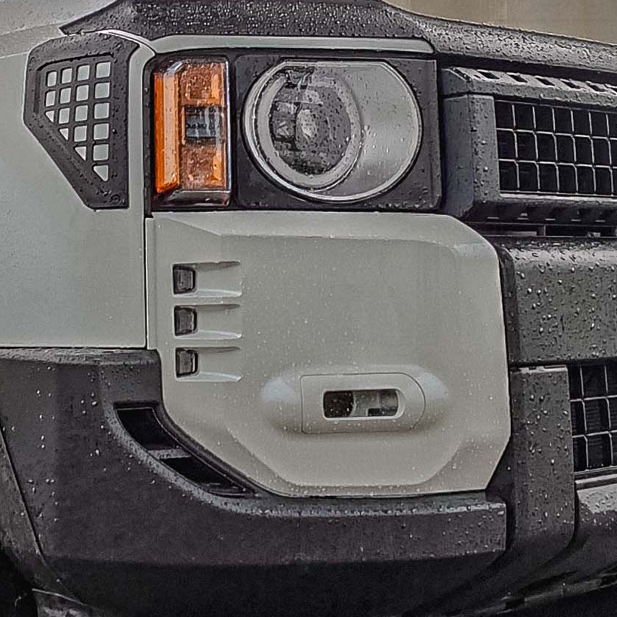 Close-up of gloss white fog light frames installed on LC250 showing precise ABS moulding and front bumper integration