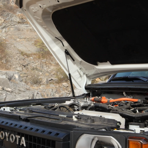 Automatic gas struts smoothly lifting the hood on a Toyota Land Cruiser LC250 engine bay