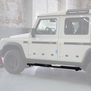 Text	An image showing the Defender-Style Fixed Side Steps installed on an INEOS Grenadier. The steps feature a flat-platform design with a black powder-coated finish, supported by durable steel brackets and integrated anti-slip pads.