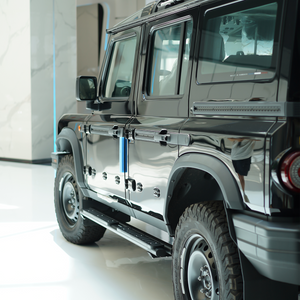 An image showing the Dual-Tube Fixed Side Steps installed on the side of an INEOS Grenadier. The steps are made from black powder-coated aluminium alloy and clearly show the double-bar structure and integrated anti-slip step pads.