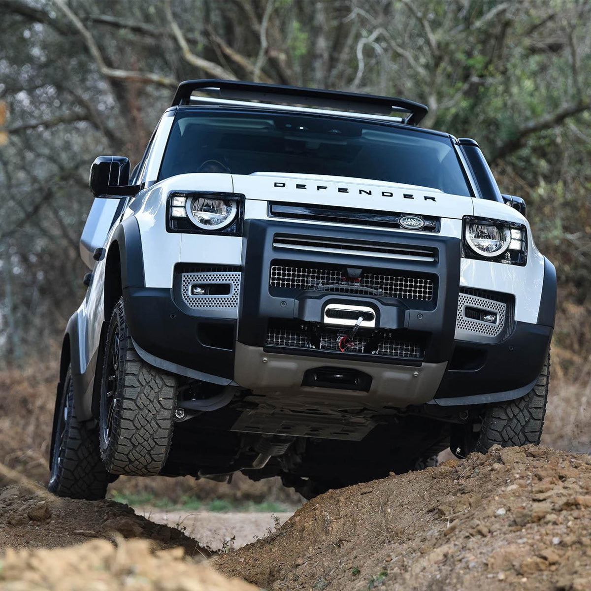 PLOMOR ABS front bumper corner trim installed angled view on Defender