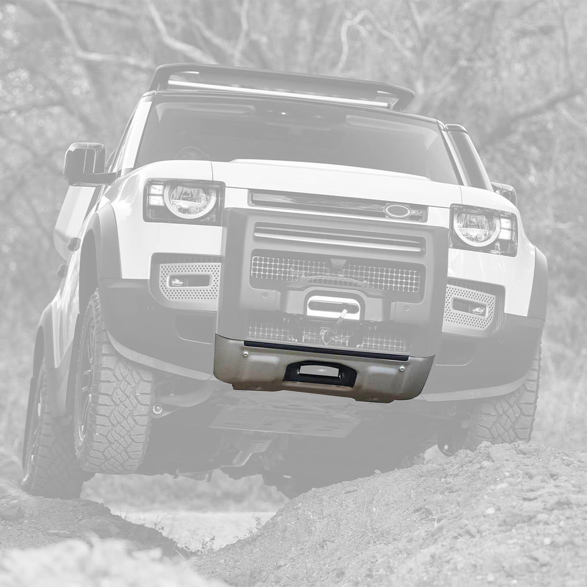PLOMOR ABS glossy black front bumper corner trim installed on Defender