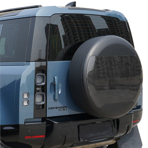 PLOMOR Carbon Fibre Spare Wheel Cover Installed on Defender in Daylight