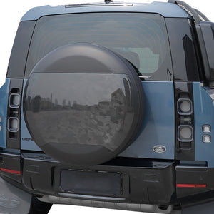 PLOMOR Carbon Fibre Spare Wheel Cover Installed on Defender in Rugged Terrain