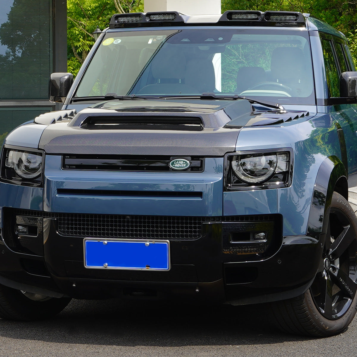 PLOMOR Defender 110 carbon fiber engine hood installed angled view
