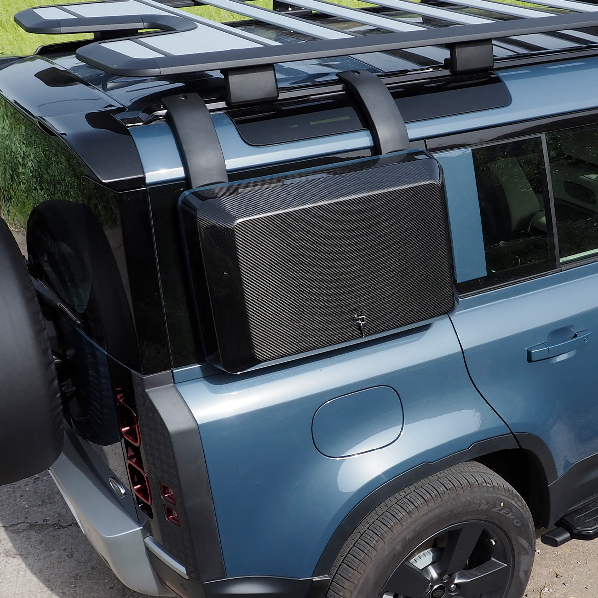 PLOMOR carbon fibre side storage box installed on Land Rover Defender 110