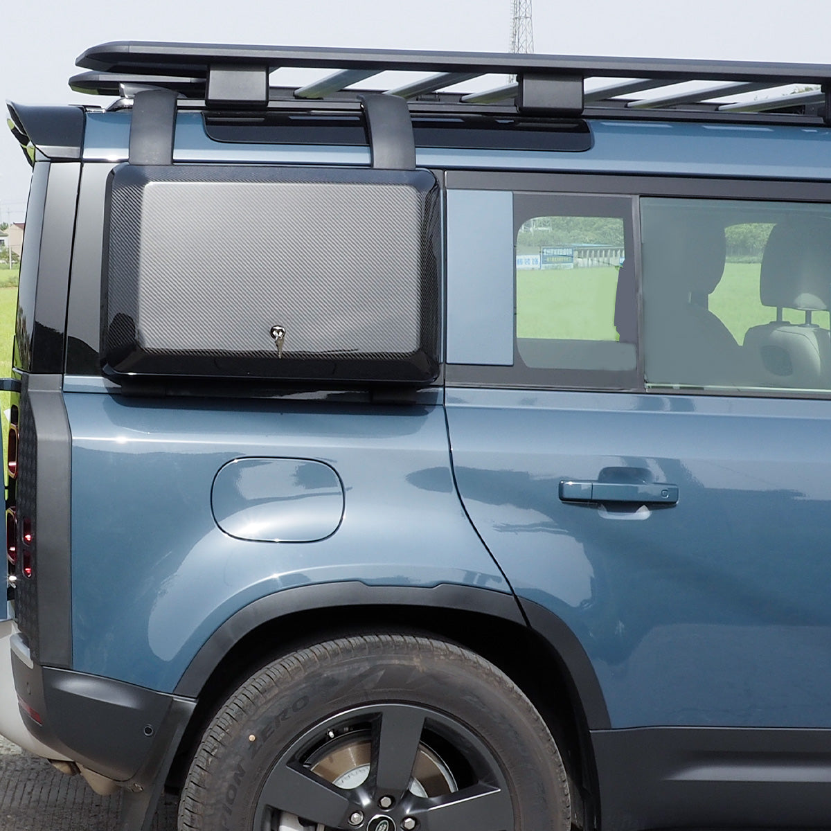 PLOMOR carbon fibre side storage box installed on Land Rover Defender 130