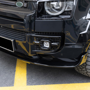 Close-up of PLOMOR ABS front lip for Defender 90 110 130 featuring gloss black finish and aerodynamic styling