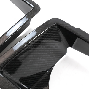 Close-up of PLOMOR dry carbon headlight cover highlighting glossy, motorsport-inspired finish