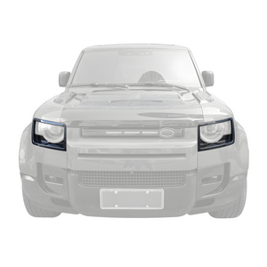Front view of PLOMOR dry carbon headlight covers installed on Land Rover Defender 90/110/130